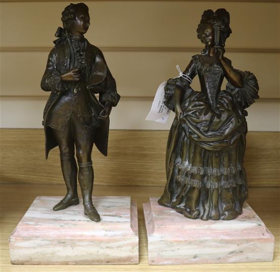 A pair of 19th century bronze figures of an elegant lady and a gentleman